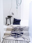 Blue and white rug with animal-skin motif and blue cushion