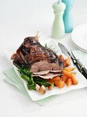 Roast leg of lamb, partly sliced, with vegetables