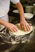 Pizza dough being stretched
