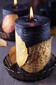 Candles decorated with painted autumn leaves