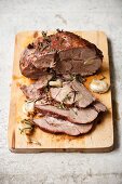 Roast lamb with rosemary and garlic, partly sliced