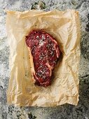 Spiced beef steak on baking parchment