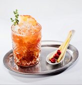 Fruit cocktail with apple and cranberries on a silver tray