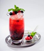 Fruit cocktail with berry juice on a silver tray