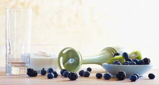 Still life featuring blueberries, kiwi and kitchen utensils