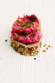 A slice of bread with beetroot cream cheese