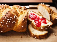 Plaited bread with butter and jam