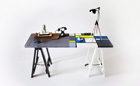 Contrast of industrial and modern styles - vintage accessories on grey half of table with stencilled numbers and Mondrian pattern in cool colours