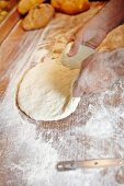 Bread dough on a floured wooden board