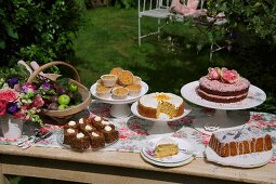 A cake buffet in a sunny garden