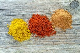 Three mounds of different spices from above