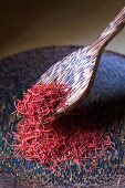 Saffron threads on a plate with a wooden spoon