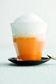 A carrot and orange cappuccino