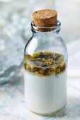 Homemade, softening bath milk made with almond oil and violets