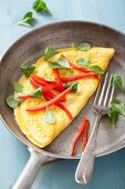 An omelette with pepper and basil