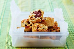 Mini apple and raspberry pies with lattice lids for a picnic