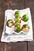 Quails eggs, cheese, ham and peppers in egg-shaped aspic