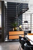 Interior staircase with floor-to-ceiling landing balustrade in open-plan living area