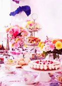 A tea party with cake, cupcakes and sandwiches