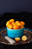 Kumquats in blue ceramic bowl