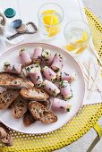 Hearts of palm wrapped in ham with bread and lemon water (Italy)