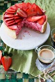 Strawberry mousse cake, sliced, and a cup of coffee