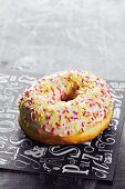 An iced doughnut with sugar sprinkles