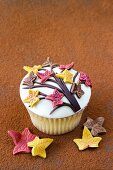A spiced cupcake decorated with sugar leaves
