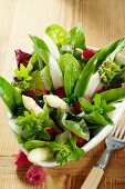 Wild herb salad with asparagus and raspberries