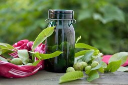 A jar of green walnuts