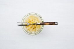 Sauerkraut in a jar with a fork