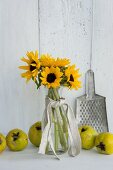Sunflowers, quinces and metal grater