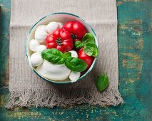 A bowl of tomatoes, mozzarella and basil