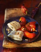 Cod fillets with marinated red peppers and pine nuts
