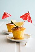 Caipirinha-soaked cakes garnished with limes and cocktail umbrellas
