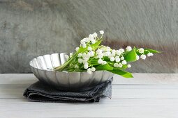 Lily of the valley in metal dish