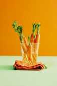 Fresh baby carrots in a glass of water