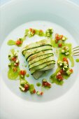 Roasted goat's cheese wrapped in courgette with a tomato and wild garlic vinaigrette