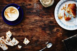 Cappuccino, sugar, a croissant and biscotti
