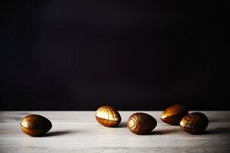 Golden chocolate Easter eggs on a wooden surface