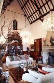 Living room with antique furnishings in historical building with steeply pitched ceiling and Gothic, gable window