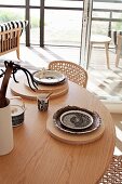 Place settings on wooden boards on round wooden table