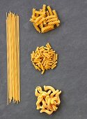 Various types of pasta on a slate sheet