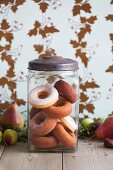 A jar of sugared and iced doughnuts