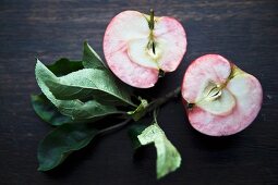 A halved apple with leaves