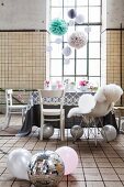 Vintage industrial interior used as party location with delicate, romantic decorations and disco ball