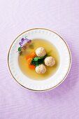 Clear broth with carrots and matze dumplings