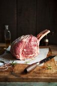 A rack of beef ribs on a chopping board