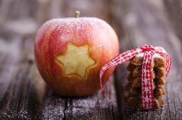 A star carved into an apple and a stack of cinnamon stars