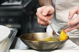 A chef working in a commercial kitchen